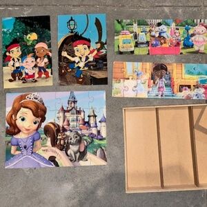 5 wooden puzzles in wooden case. Doc McStuffins, Sofia the First, Jake and the N